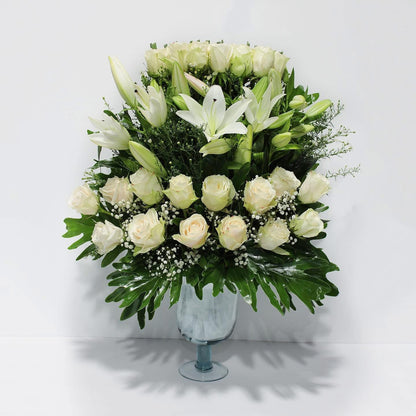 4 Lilies & 30 White Imported Flowers in Rounded Vase